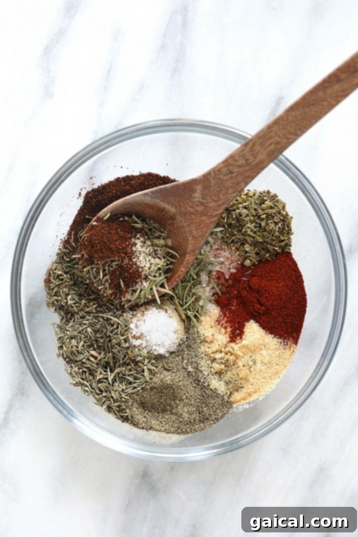 Ditch the store-bought turkey seasoning and use the most Flavorful Turkey Seasoning made with 9 ingredients you can actually pronounce. Winner winner, turkey dinner! A bowl filled with a rich, colorful blend of homemade turkey seasoning, ready to be applied to a turkey.