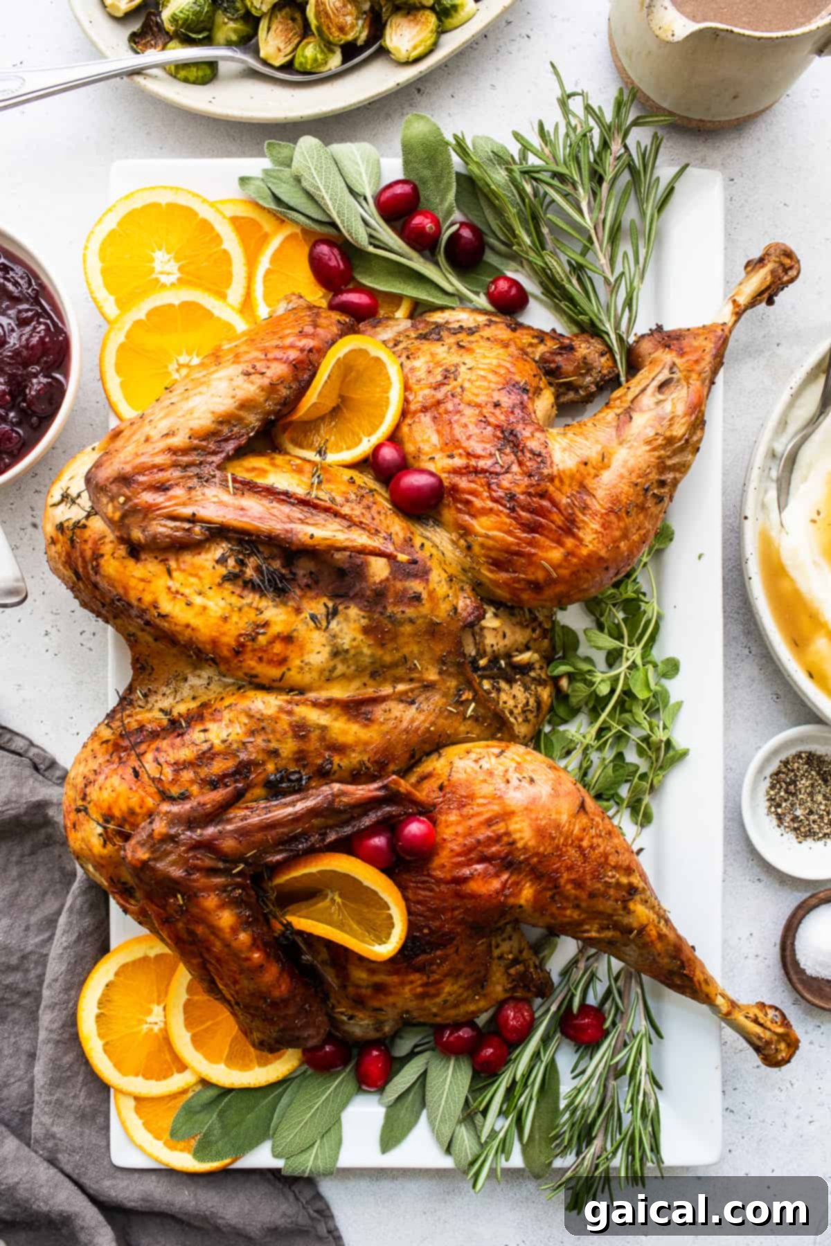 Ultimate Turkey Blend 4 A beautifully roasted turkey, golden brown and glistening with juices, garnished with fresh herbs, showcasing the perfect result of the turkey seasoning.