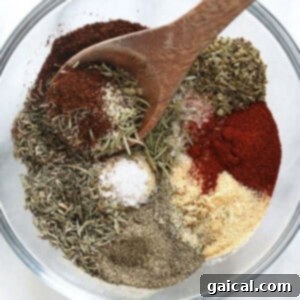 Ultimate Turkey Blend 5 Spices in a bowl with a wooden spoon, perfect for flavorful turkey seasoning.