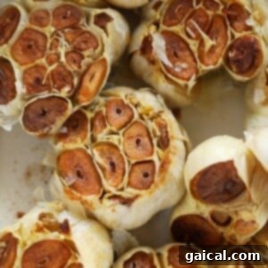 Golden roasted garlic cloves in a small baking dish, ready for serving.