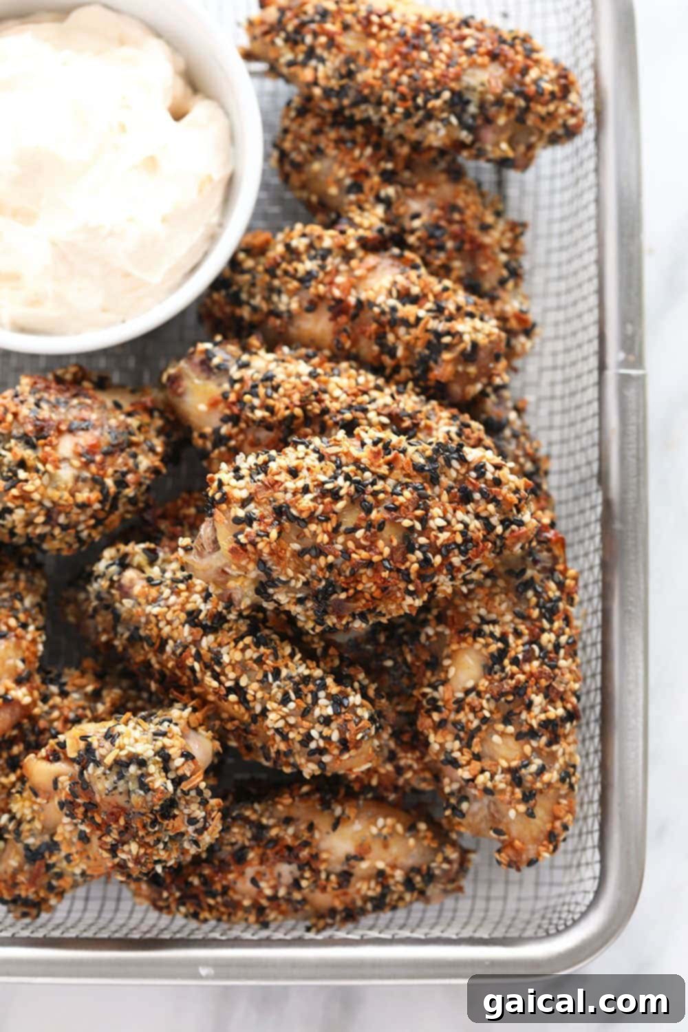 Flavorful Crispy Everything Bagel Chicken Wings Crispy Everything Bagel Seasoning Chicken Wings served in a basket with a side of creamy dip