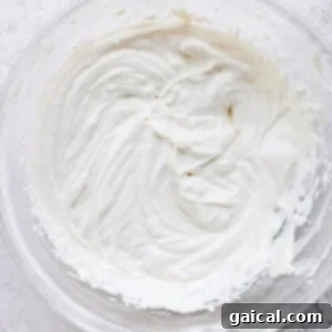 Cream cheese frosting in a bowl, showing its smooth and creamy texture.