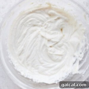 A smooth, creamy bowl of homemade cream cheese frosting, ready to be spread.