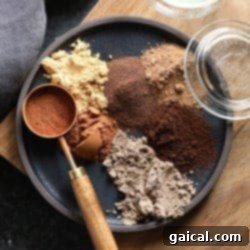 A small bowl filled with a rich, aromatic homemade chai spice mix, ready to be used in baking.