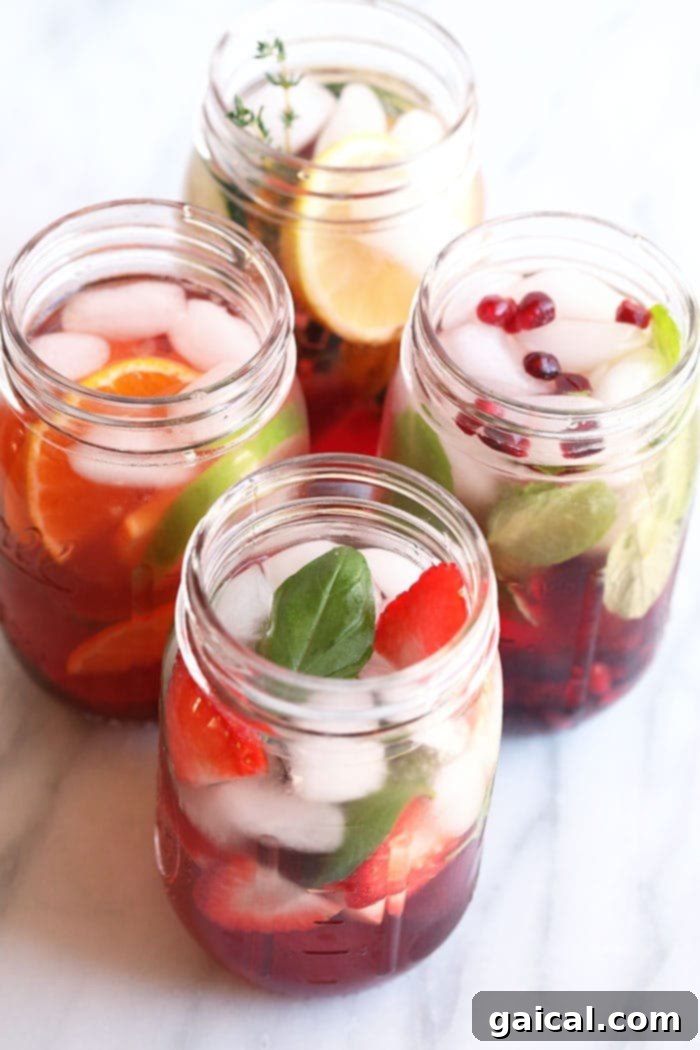 4 Fruit Infused Water Recipes A collection of four vibrant fruit-infused water recipes in mason jars, garnished with fresh fruits.