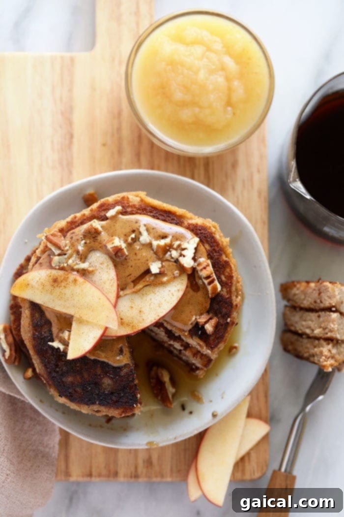 Simple & Delicious Applesauce Pancake Stack A perfectly stacked pile of fluffy applesauce pancakes on a clean white plate, ready to be adorned with toppings or enjoyed simply.