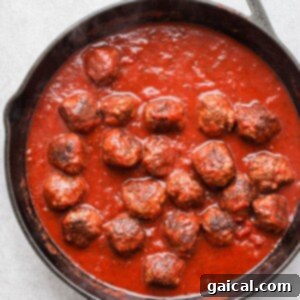 Meatballs and sauce in a pan.