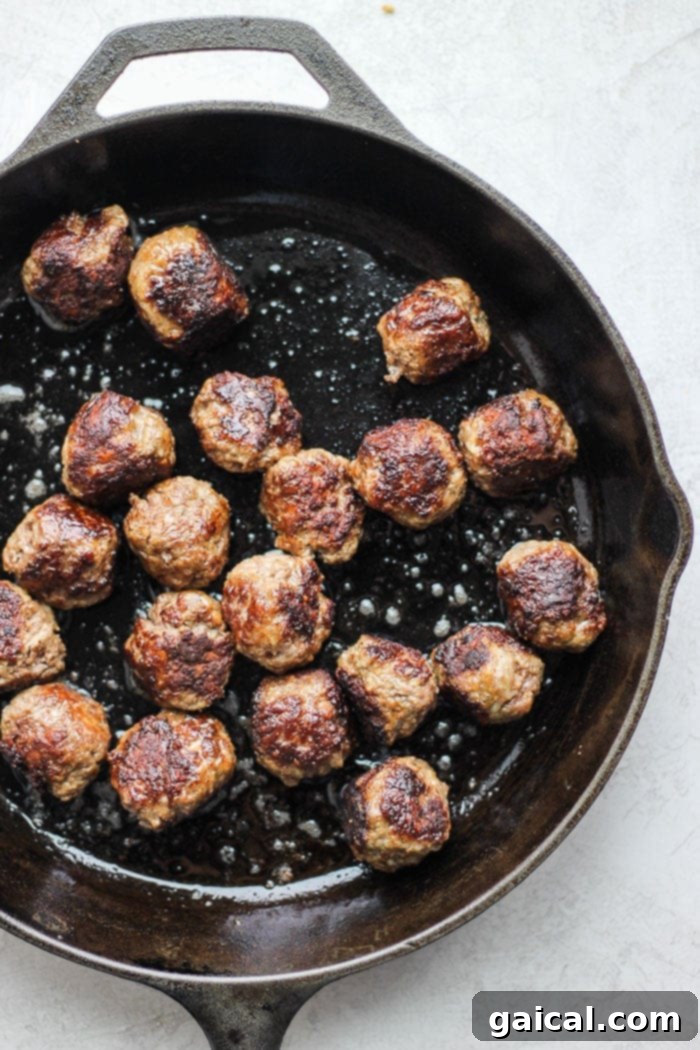 Italian meatballs in cast iron skillet.