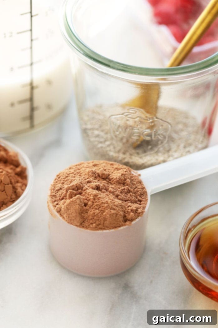 Scoop of chocolate protein powder, ready to be added to the pudding