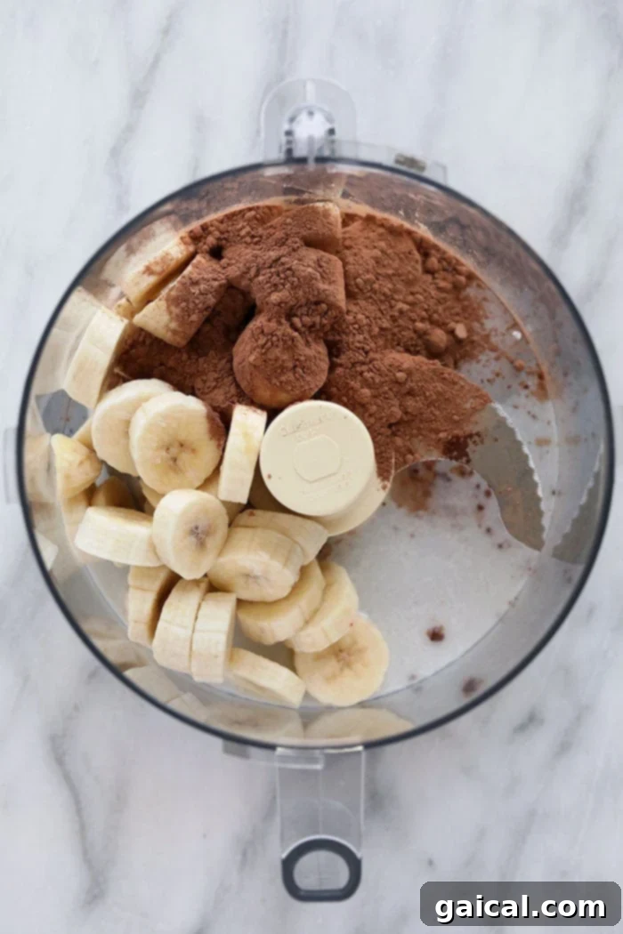 Close-up of creamy Chocolate Peppermint Banana Nice Cream in a tin, showing smooth texture and mini chocolate chips