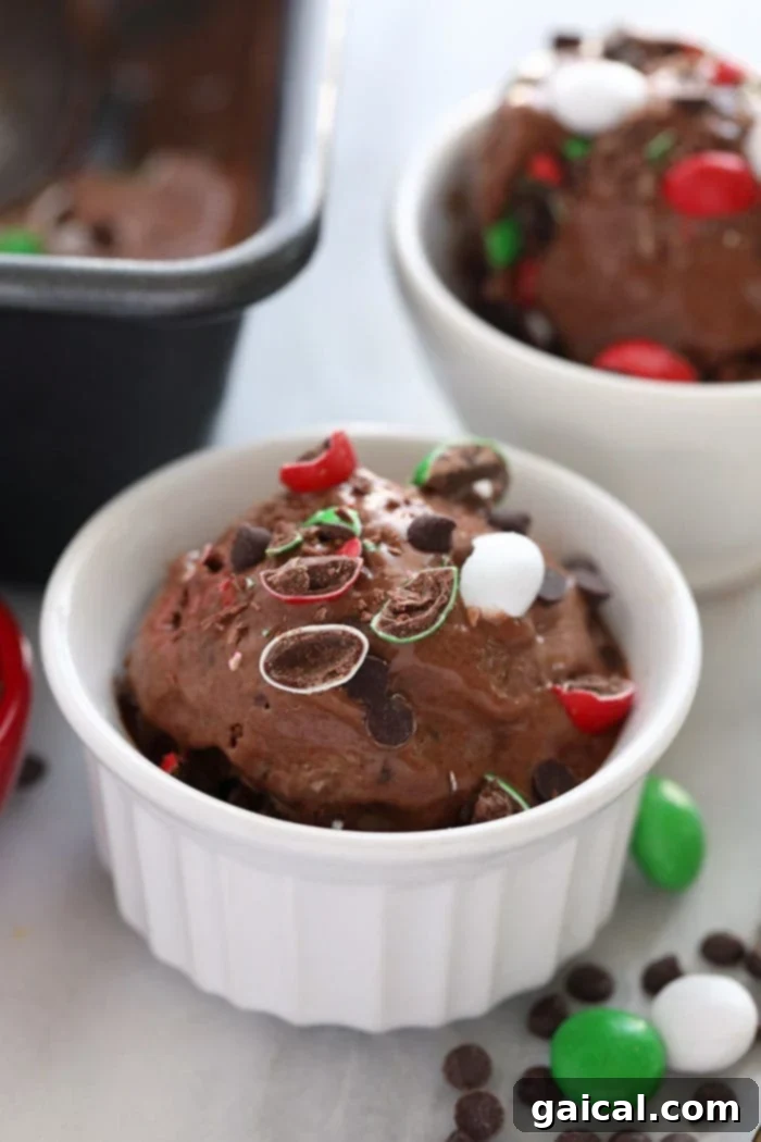 Chocolate Peppermint Banana Nice Cream served in a glass cup, topped with festive mini chocolate chips, ready to enjoy