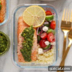 Effortless Mediterranean Salmon Meals 7 Mediterranean Salmon Meal Prep, showcasing a salmon fillet with pesto, Greek salad, and couscous in a container