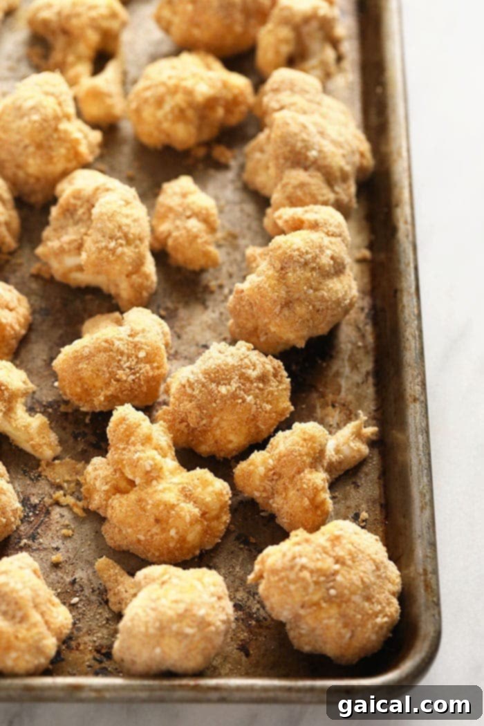 Crispy General Tso's Cauliflower 4 Baking sheet with breaded cauliflower wings ready for the oven