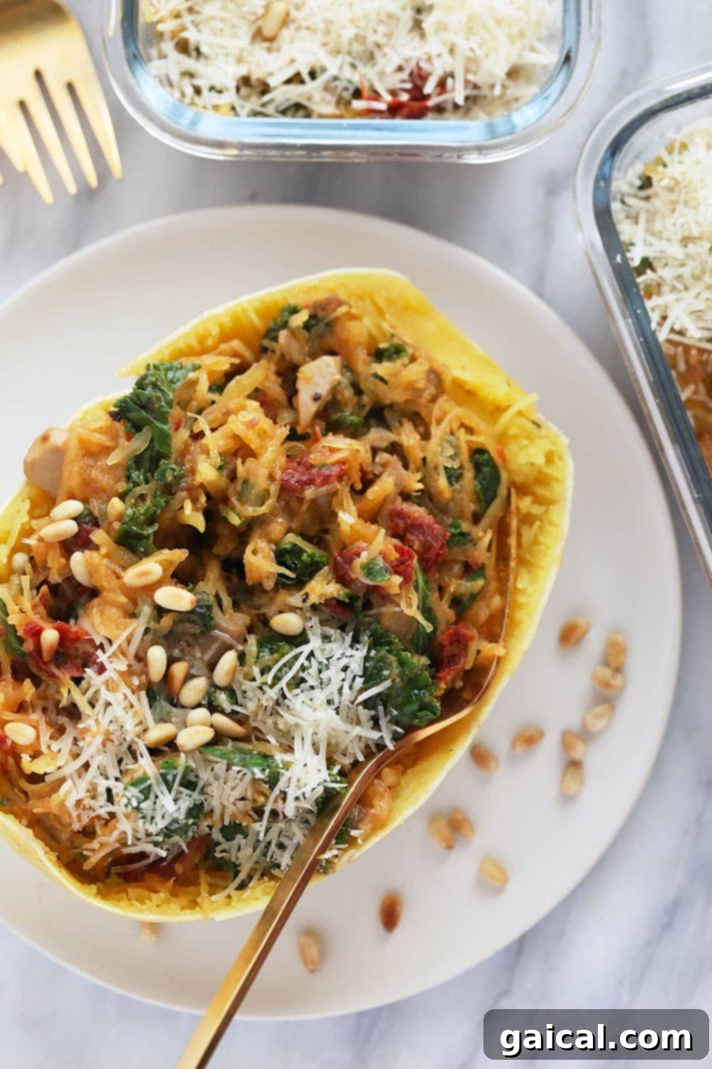 Stuffed Instant Pot Spaghetti Squash on a plate with fresh greens and pine nuts
