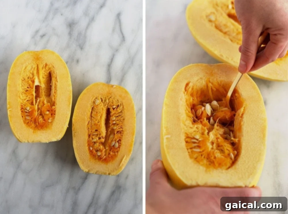 Scooping out the seeds and fibrous innards from a spaghetti squash half