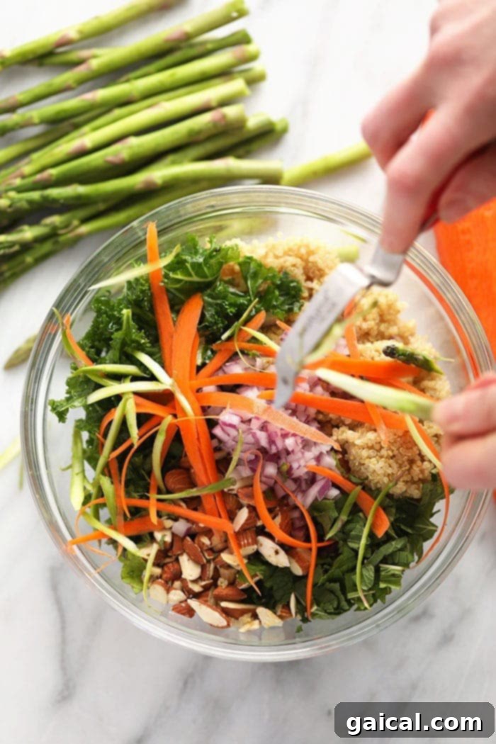 Hands demonstrating the technique of making long, thin ribbons from a carrot using a vegetable peeler.