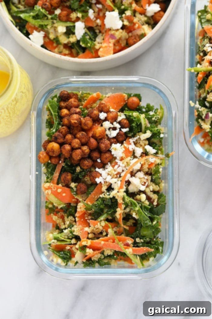 A single-serving meal prep container filled with Moroccan quinoa salad, with separate compartments for crispy chickpeas and dressing.