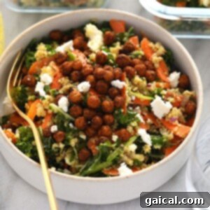 A beautifully arranged bowl of Moroccan quinoa salad with kale and carrots.