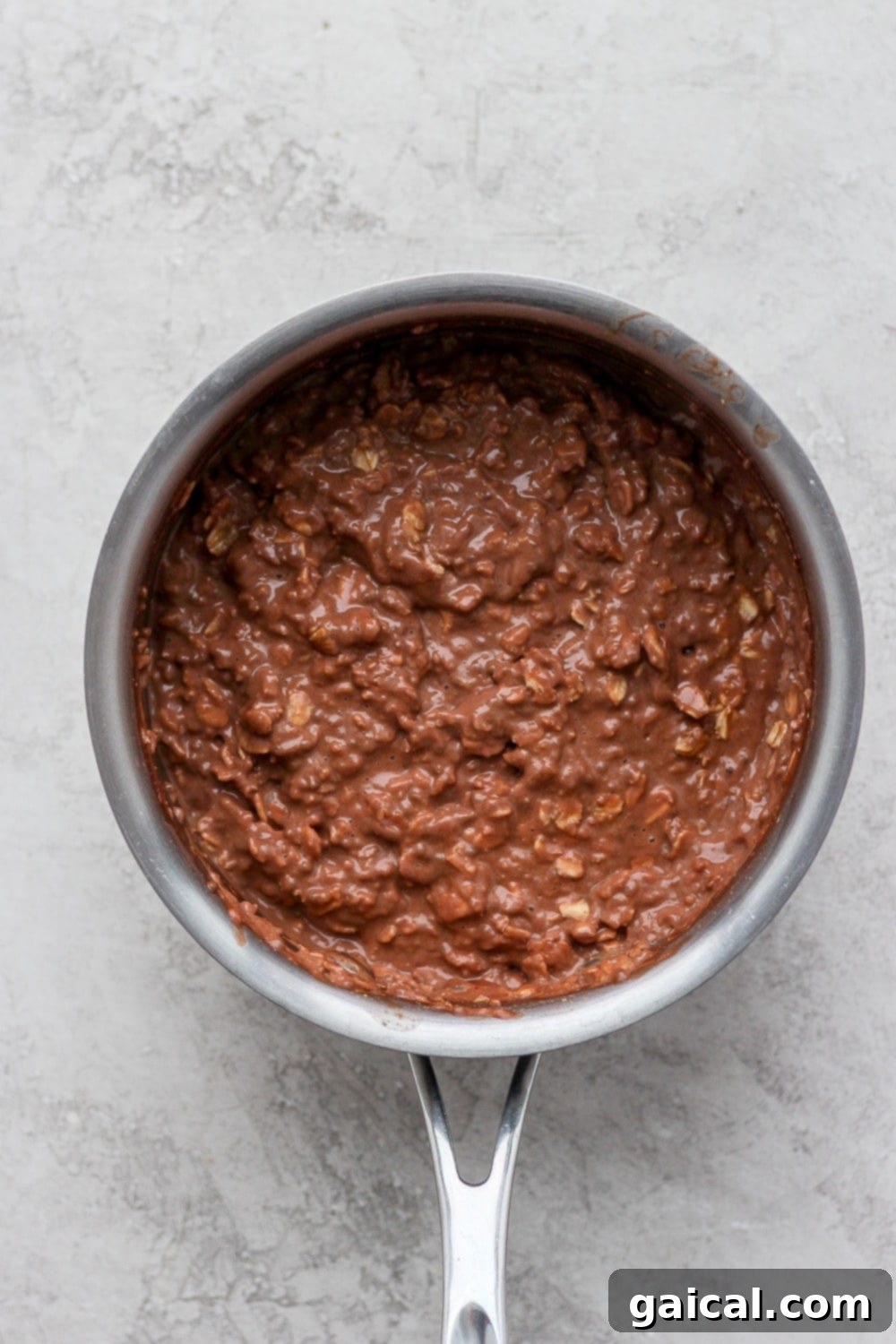 Chocolate Protein Oatmeal Ready to Serve A rich, creamy chocolate protein oatmeal in a saucepan, steaming gently, ready to be scooped into bowls.