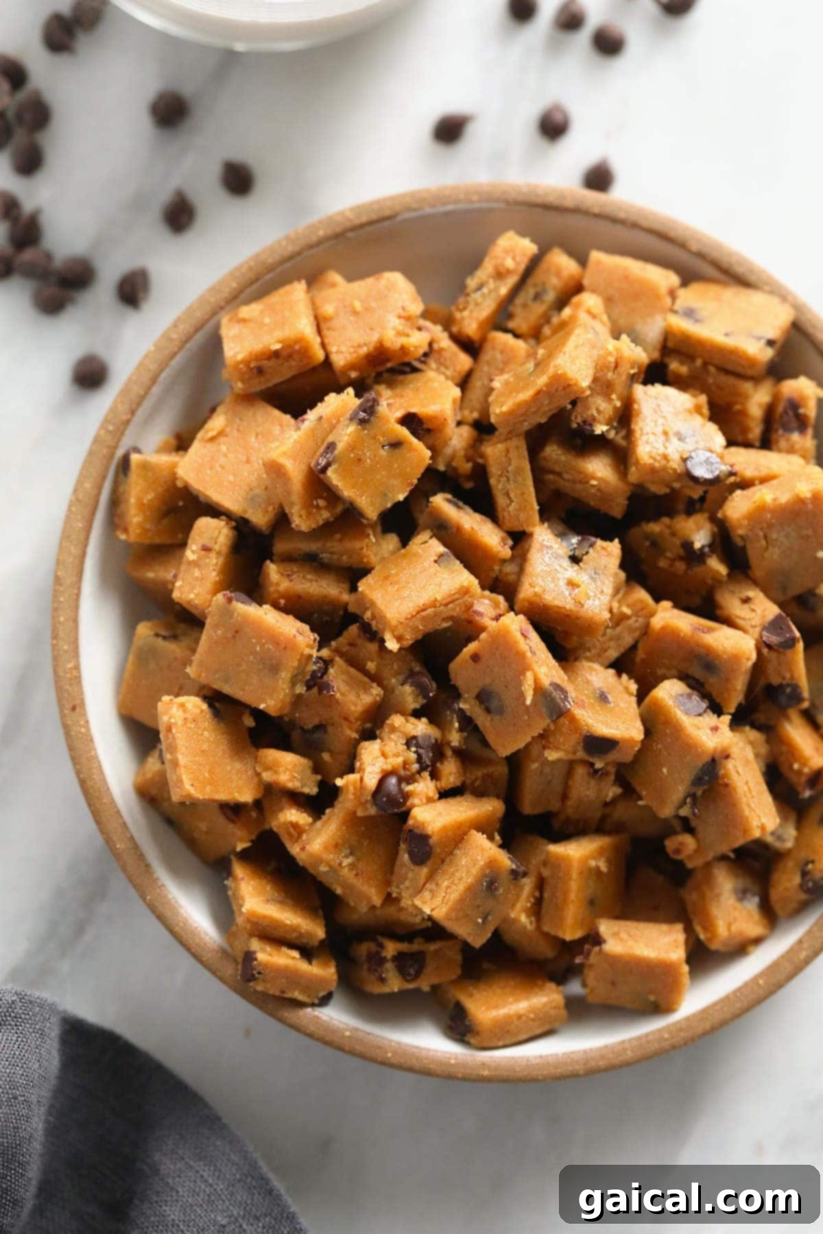Delicious and healthy vegan cookie dough bites for a guilt-free treat. Bowl filled with healthy vegan chocolate chip cookie dough bites, ready for snacking.