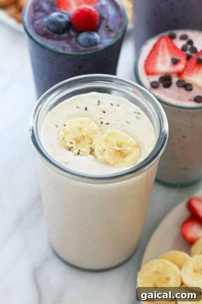 A refreshing banana protein shake in a glass with a straw, garnished with banana slices.