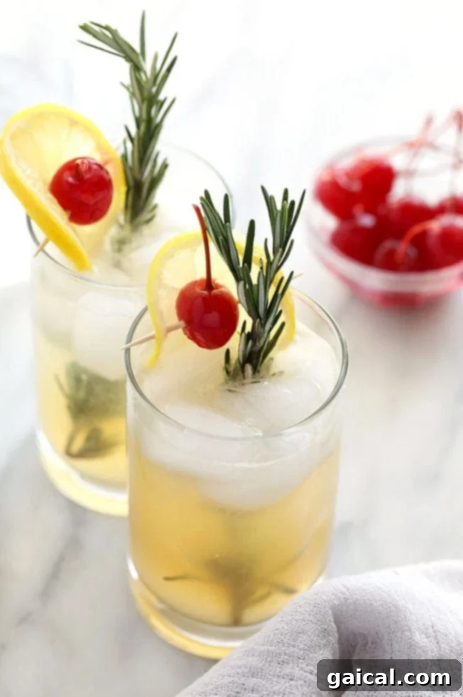 Rosemary Collins cocktail in a tall glass, garnished with a sprig of fresh rosemary and a lemon slice.