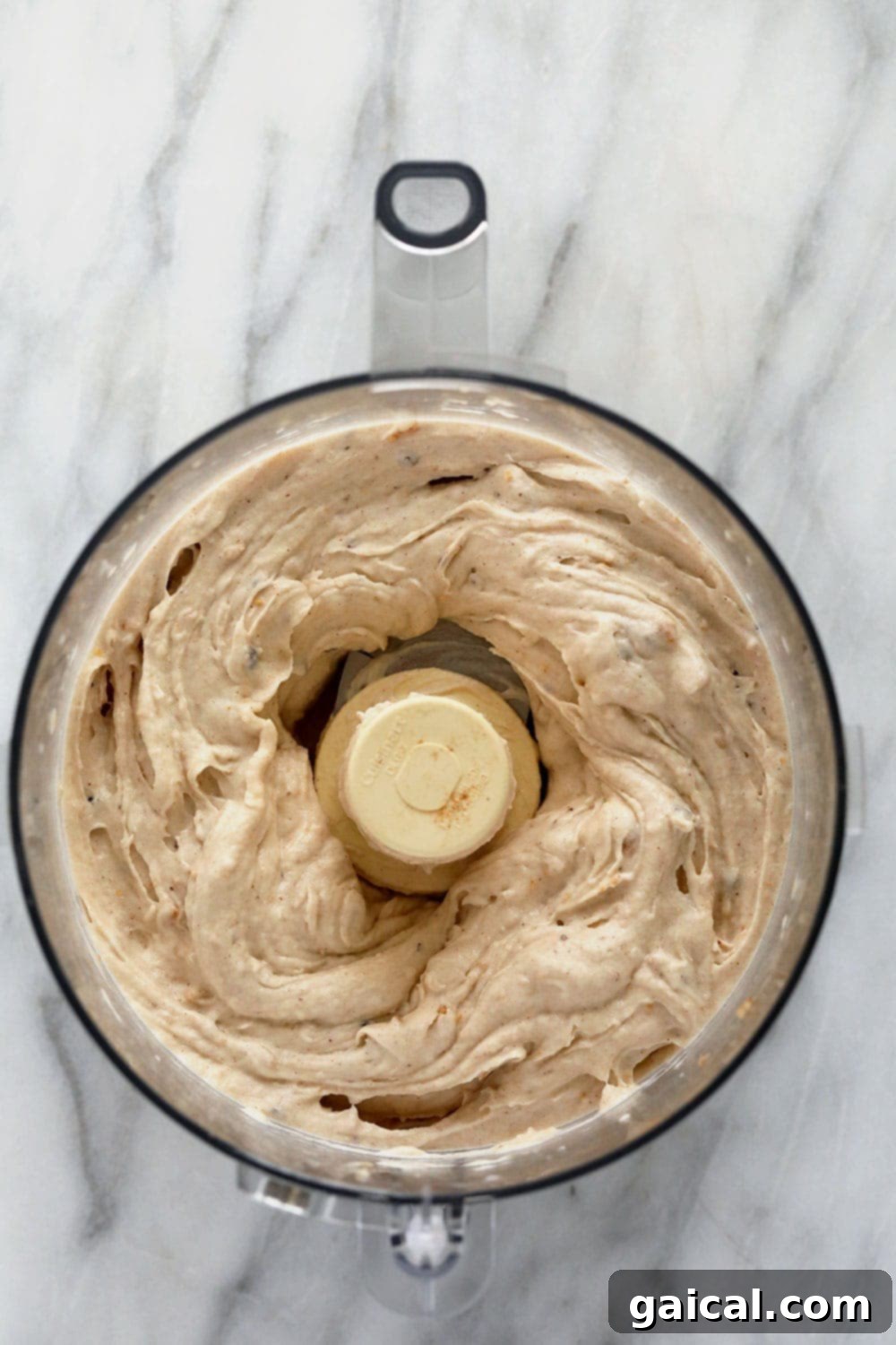 Cookie Dough Banana Bliss 5 The smooth, creamy texture of vegan banana nice cream being blended to perfection in a high-speed food processor.