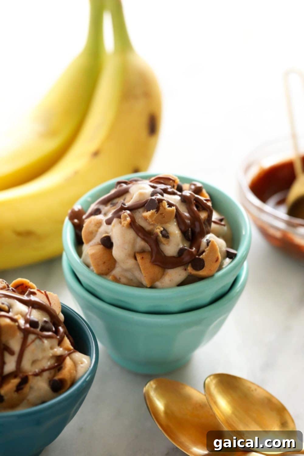 Cookie Dough Banana Bliss 8 Several bowls of freshly made vegan cookie dough banana nice cream, beautifully presented and ready to be served, highlighting the delicious texture and cookie dough chunks.