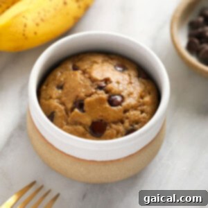 Delicious banana mug cake with chocolate chips in a bowl, ready to eat.