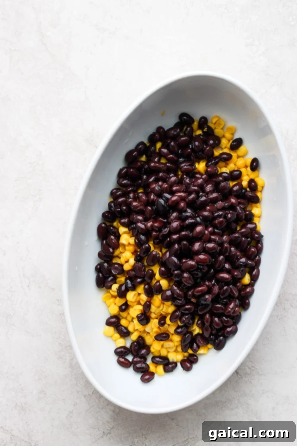 Freshly drained sweet corn and black beans, perfectly prepared and ready to be mixed into the creamy vegan queso for an authentic Mexican Street Corn Queso Dip.