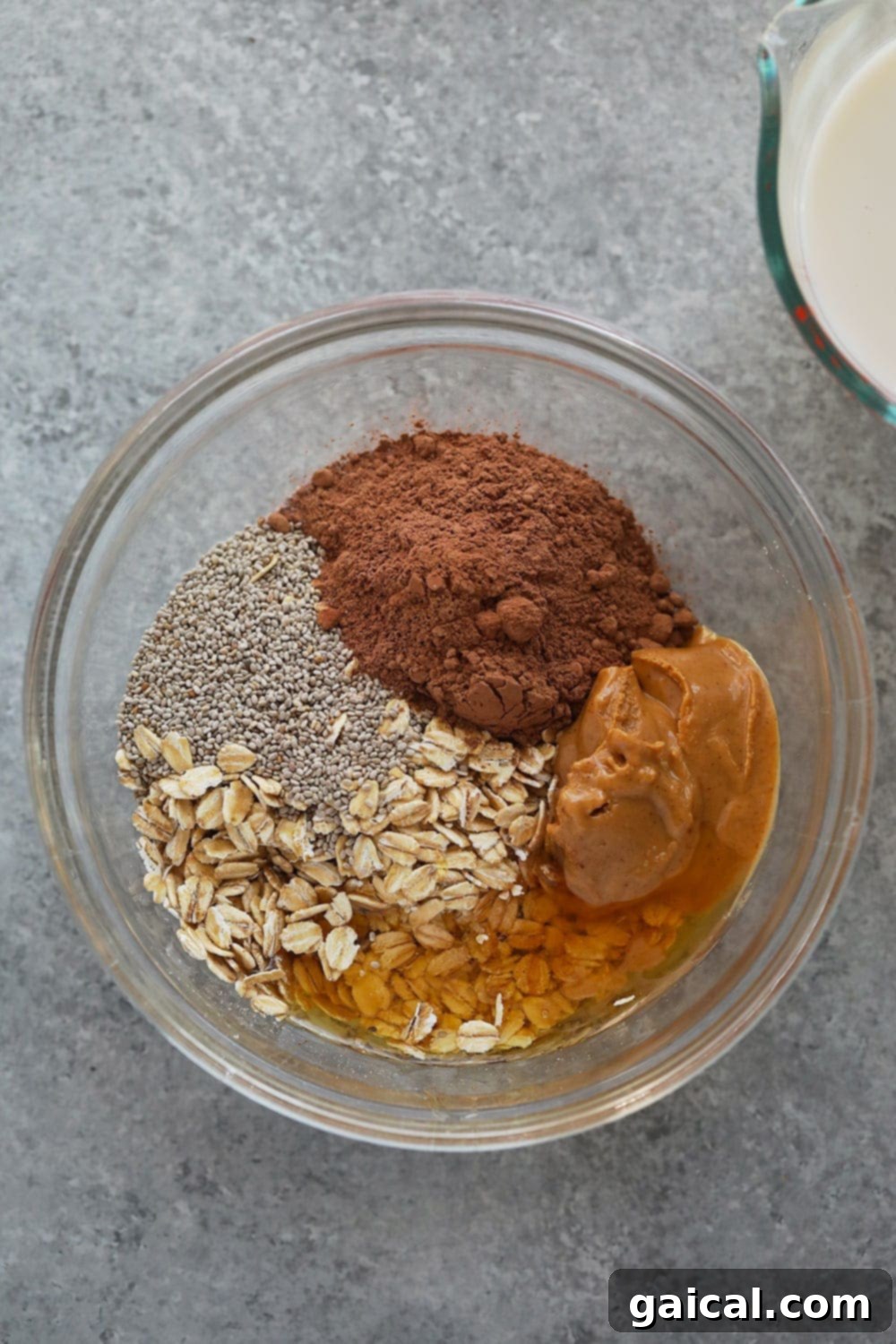 The individual ingredients for Chocolate Peanut Butter Overnight Oats laid out, showcasing their clean and wholesome nature.