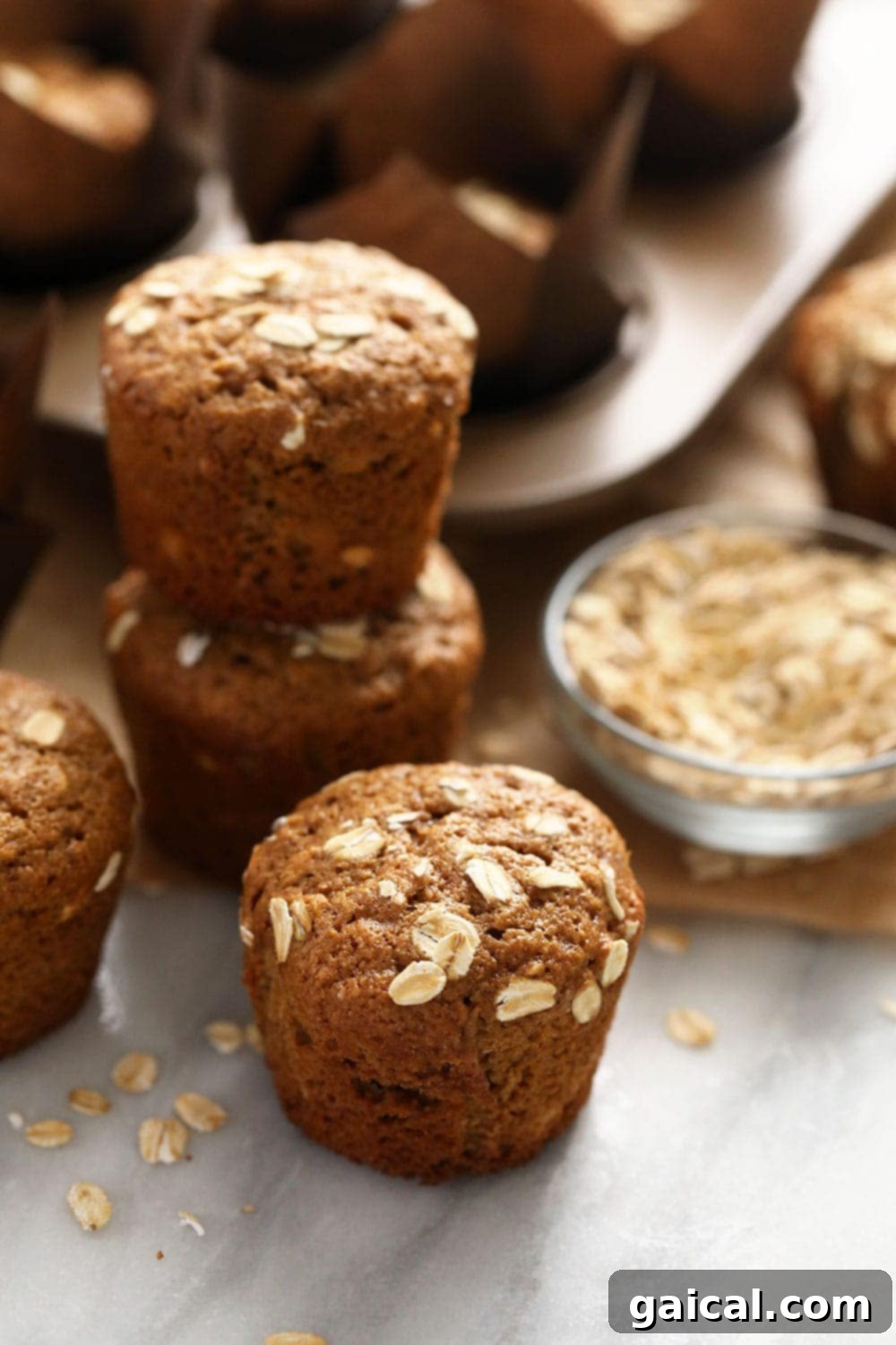 Wholesome Oatmeal Muffins 3 A stack of two healthy classic oatmeal muffins, showcasing their soft texture and wholesome appearance, elegantly presented and ready to be enjoyed.