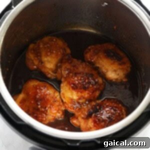 Cooked honey garlic chicken in the Instant Pot, showing its tenderness.