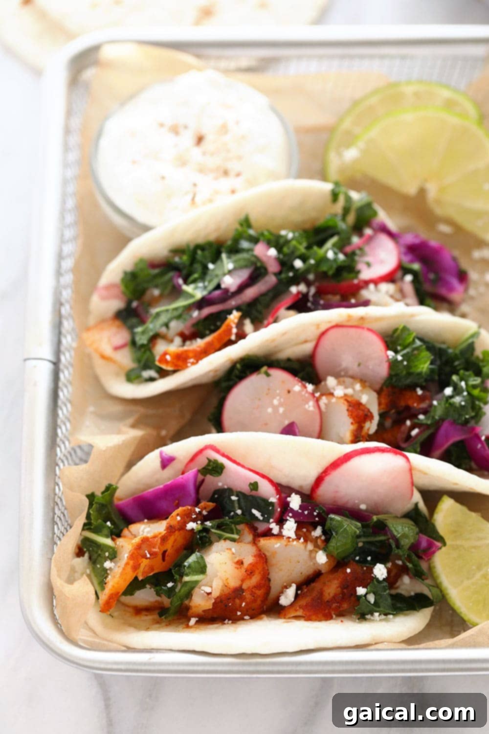 Delicious Baked Fish Tacos for a Quick Meal Fish tacos beautifully arranged in a rustic basket, garnished with fresh lime and cilantro.