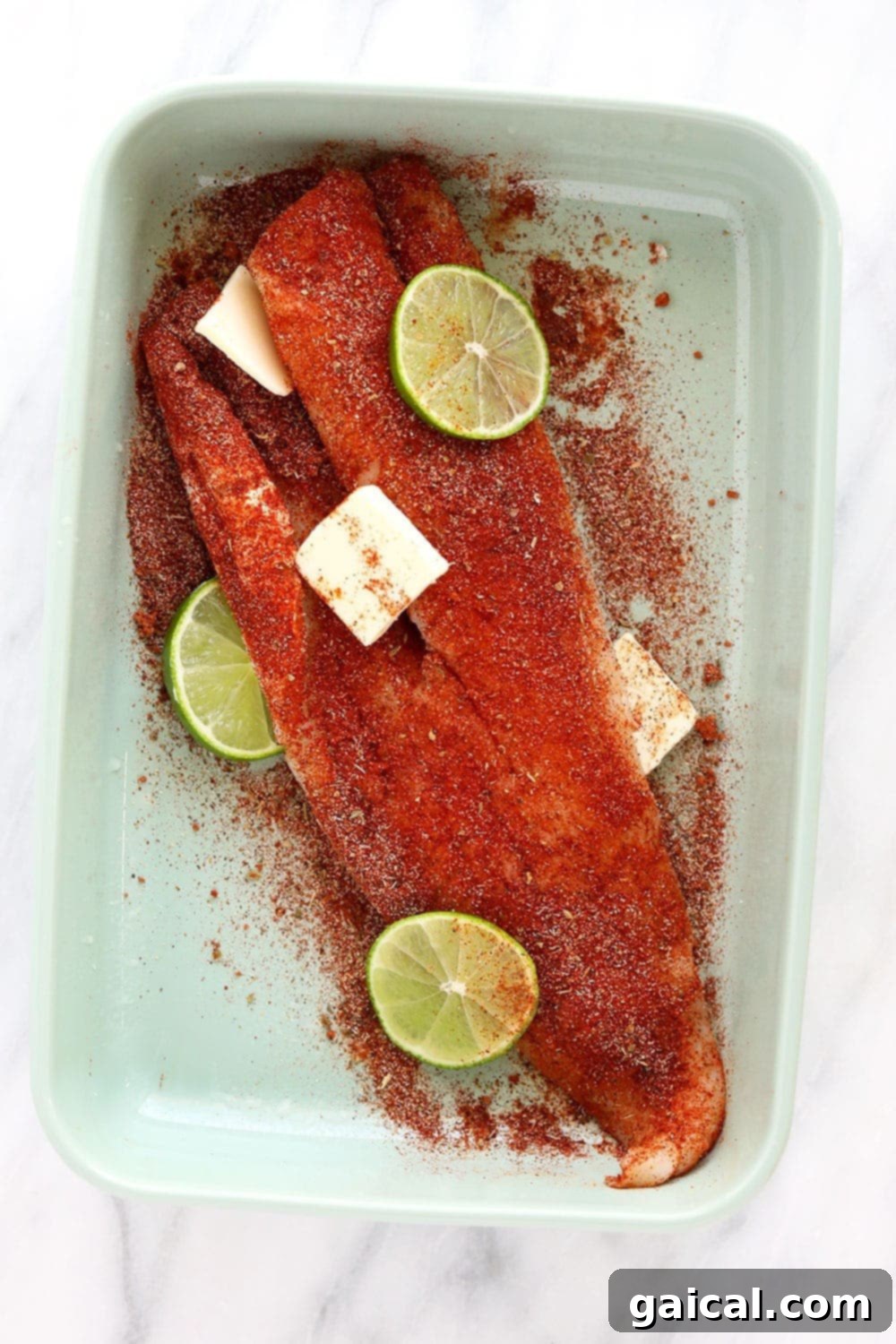 Fresh Cod Fillet Prepared for Baking A fresh cod fillet seasoned and ready for baking in a glass dish.