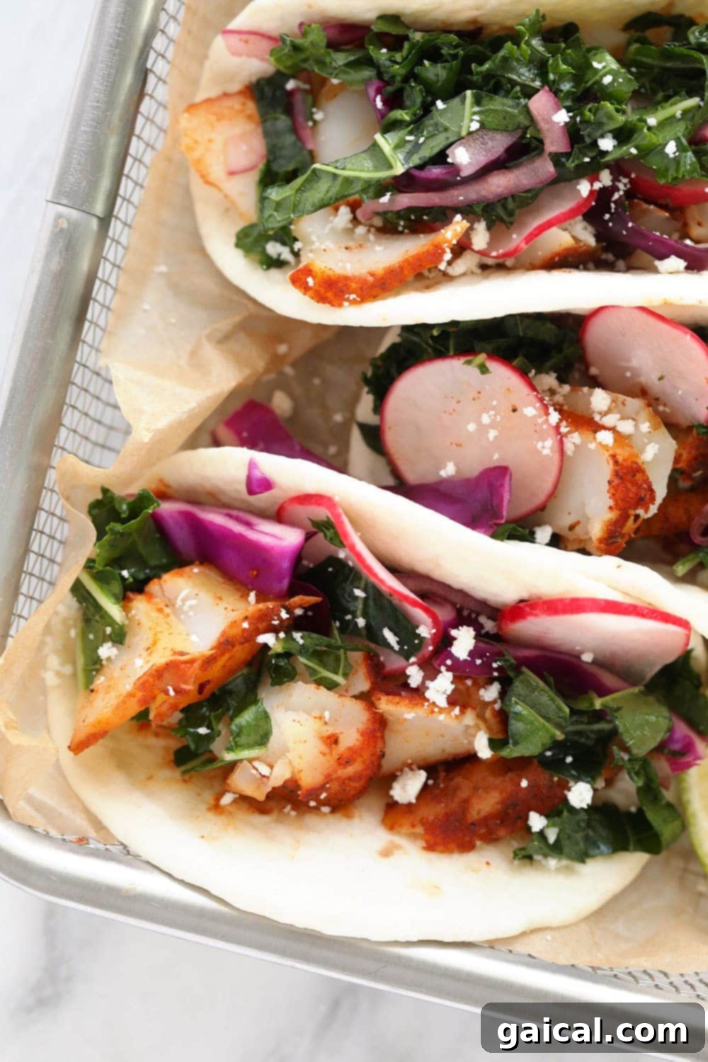 Delicious and Easy Baked Fish Tacos Two vibrant fish tacos served in a rustic basket, garnished with fresh cilantro and lime.