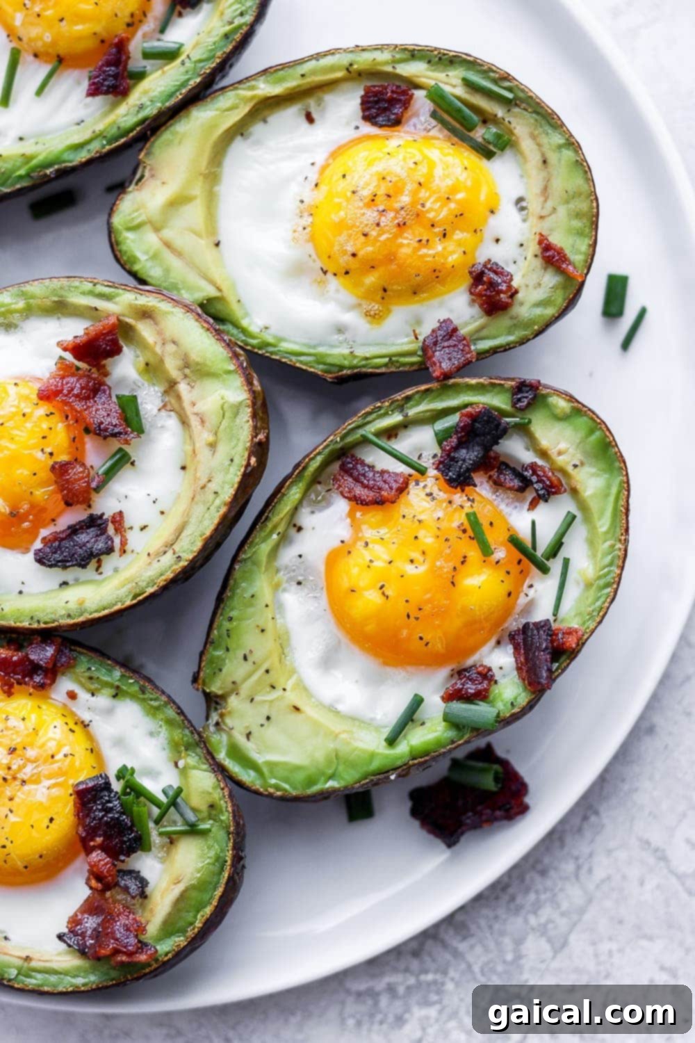 A beautifully plated avocado egg bake, garnished with fresh herbs and bacon, ready to be enjoyed.
