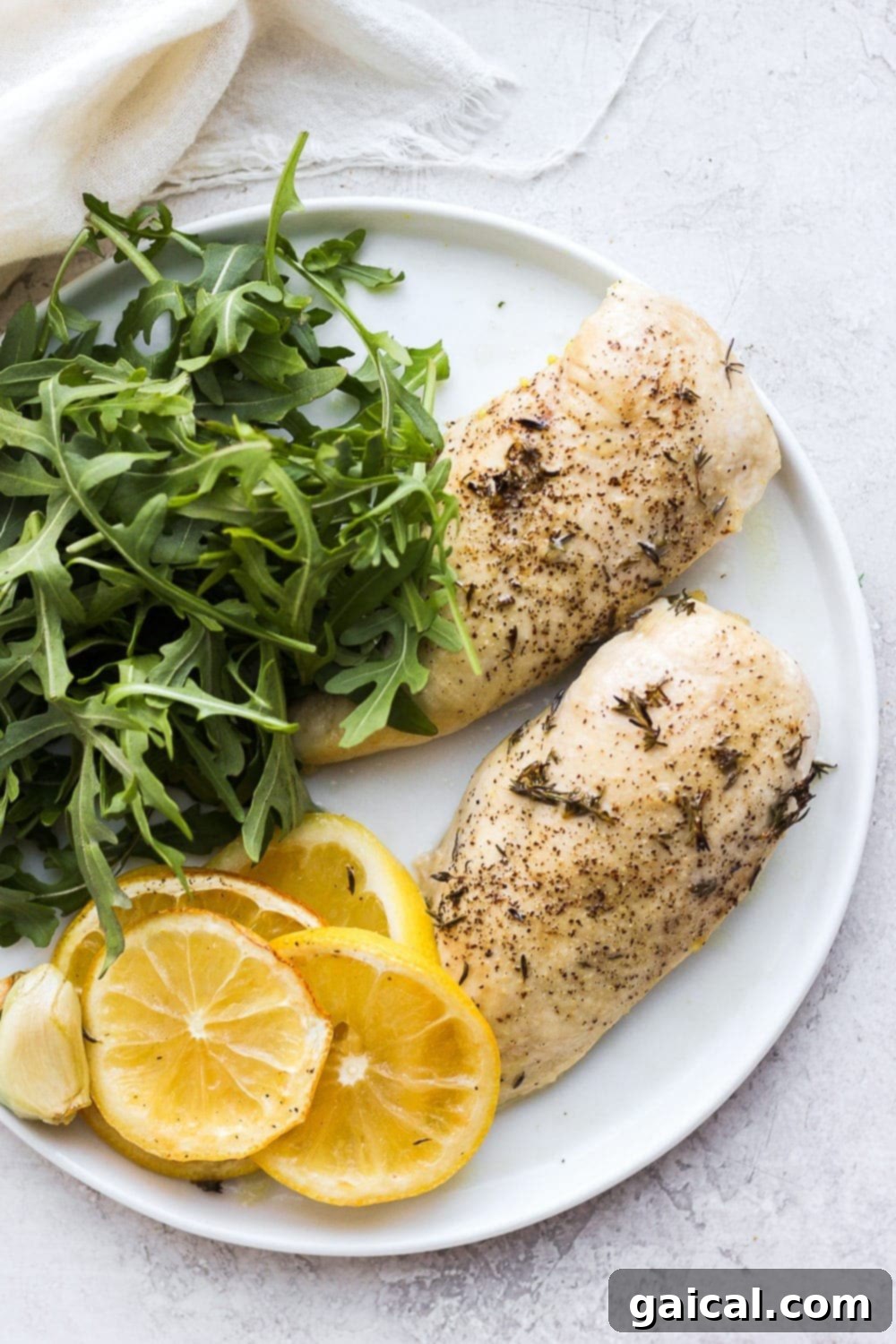 Beautifully baked lemon chicken breast on a plate, ready to be served.