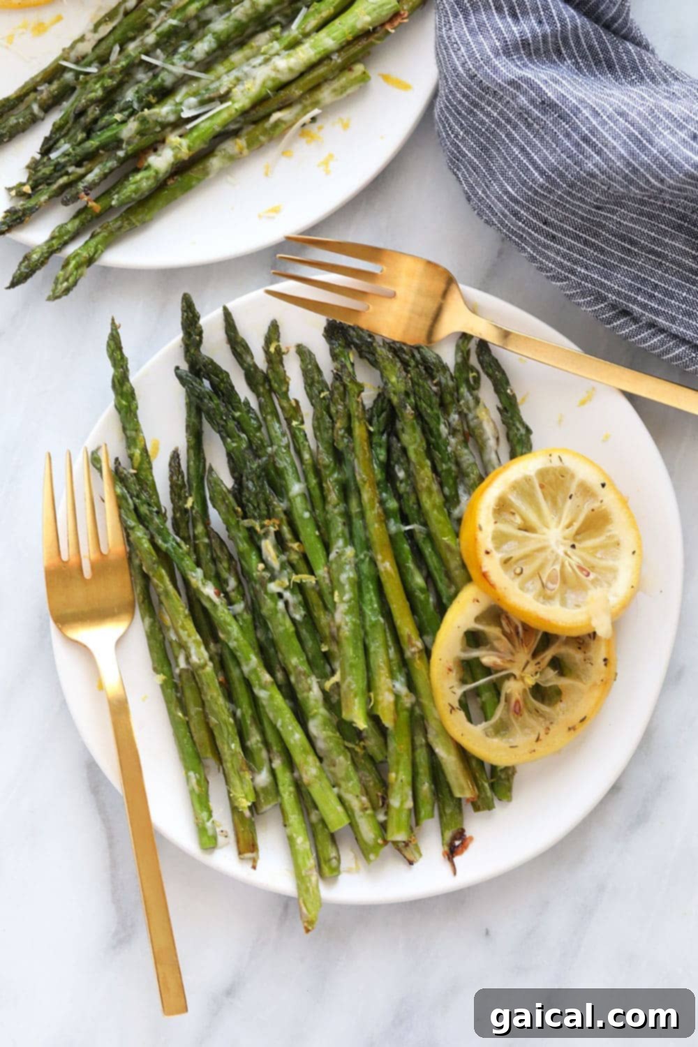 Golden Roasted Asparagus 2 Asparagus on a plate, beautifully garnished with fresh lemon zest.