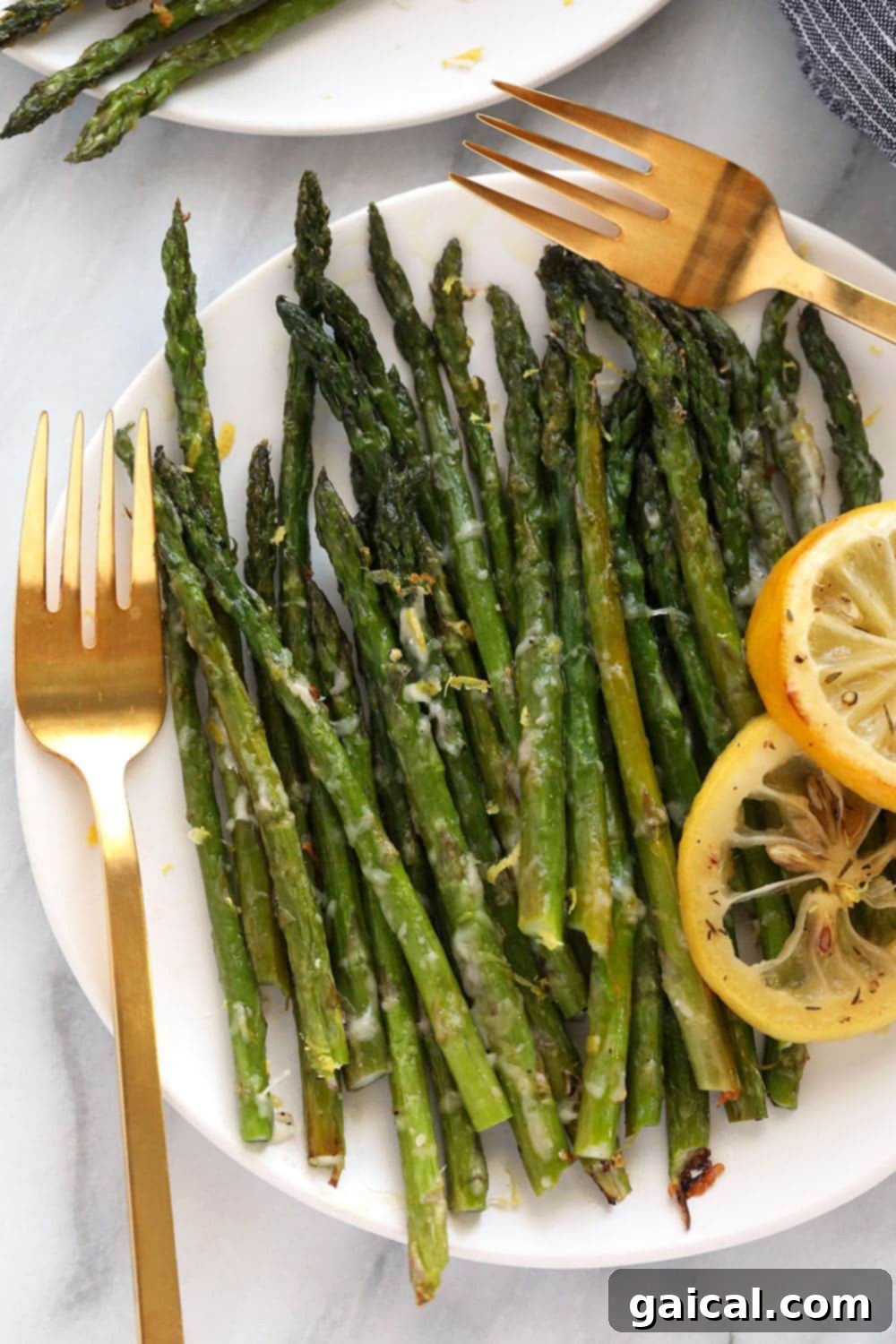 Golden Roasted Asparagus 6 Perfectly oven roasted asparagus presented on a white plate.