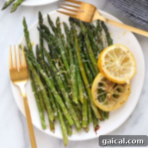 Golden Roasted Asparagus 7 Asparagus on a plate with lemon garnish, showcasing the final dish.