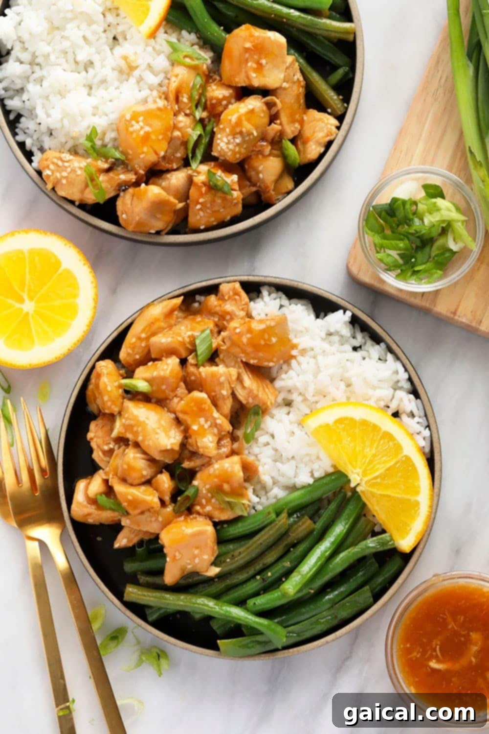 A plate of Instant Pot Orange Chicken with rice and green beans, showcasing the vibrant sauce and tender chicken.
