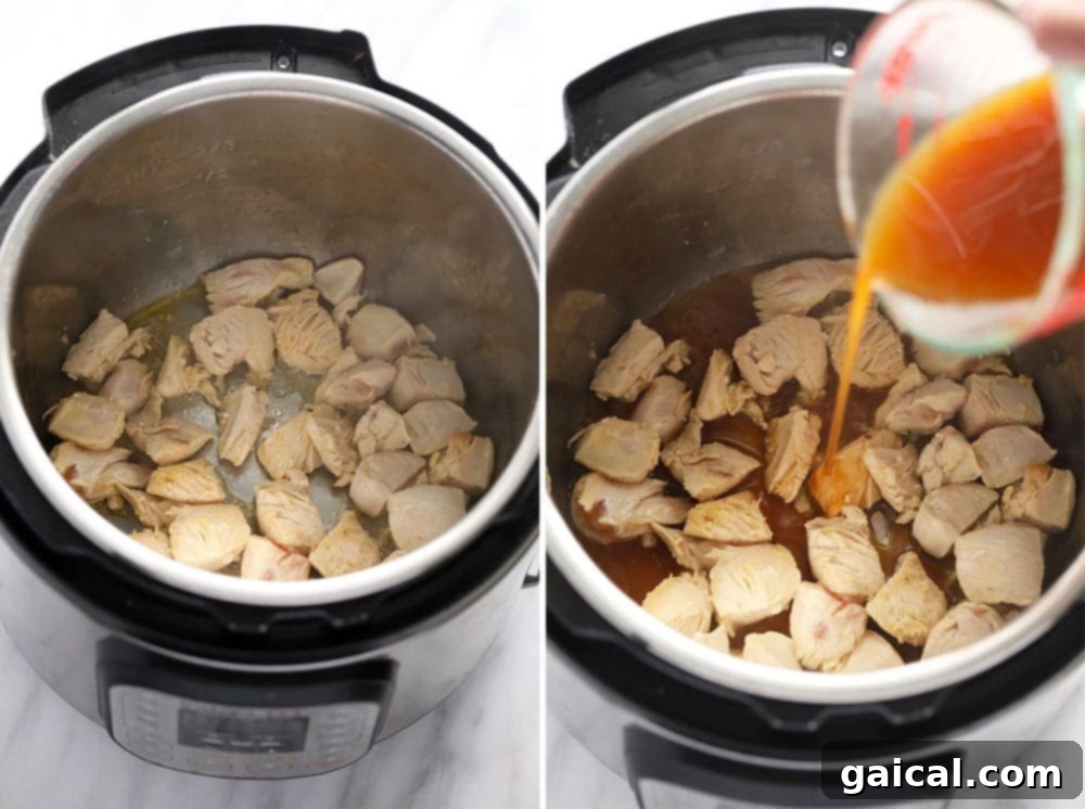 Diced chicken breast browning in an Instant Pot, a crucial step for building flavor.