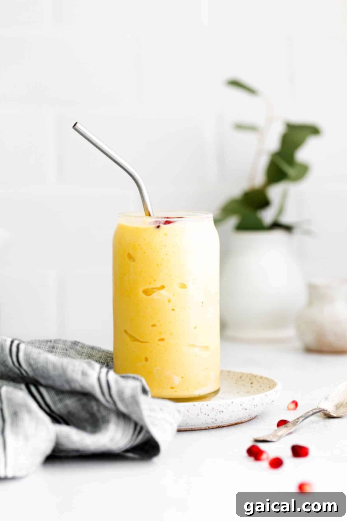 Tropical Mango Bliss 6 A perfectly blended mango smoothie in a glass, ready to be enjoyed as a refreshing beverage or topped for a smoothie bowl.