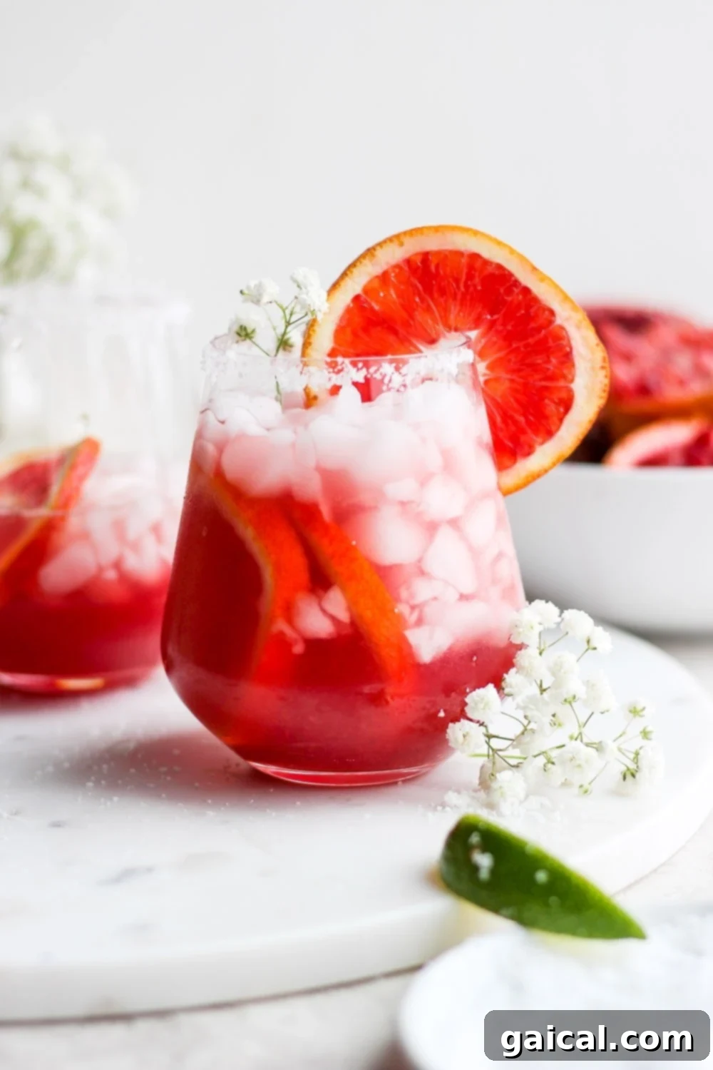 Elevate your margarita with this vibrant blood orange recipe, perfect for any occasion! Blood orange margarita in a glass, garnished with a blood orange slice