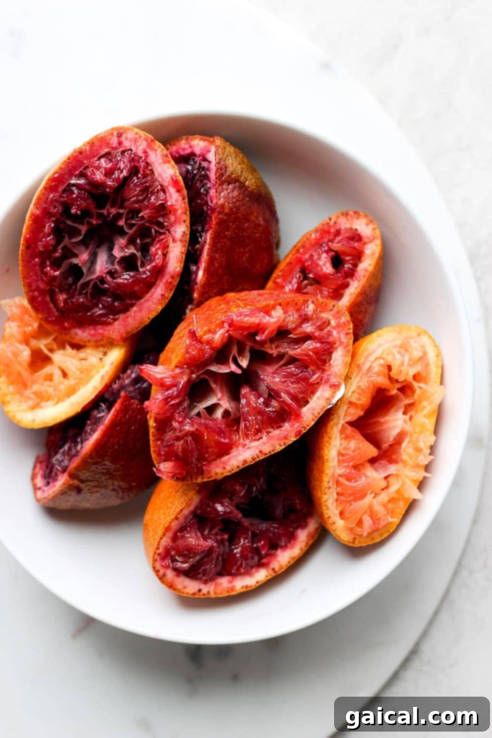 Freshly squeezed blood oranges, ready for mixing into a delicious margarita. Freshly juiced blood oranges, showcasing their vibrant color