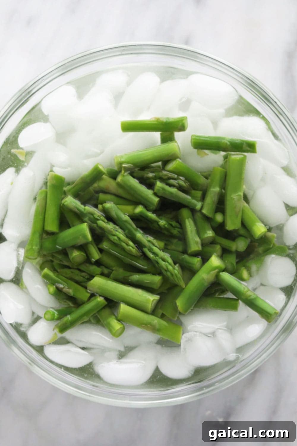 Blanching fresh green asparagus in a pot of boiling water