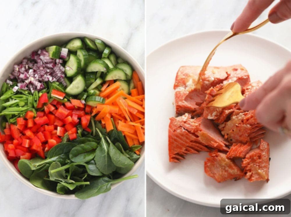 A vibrant plate filled with fresh vegetables, flaky salmon, and maple roasted cashews