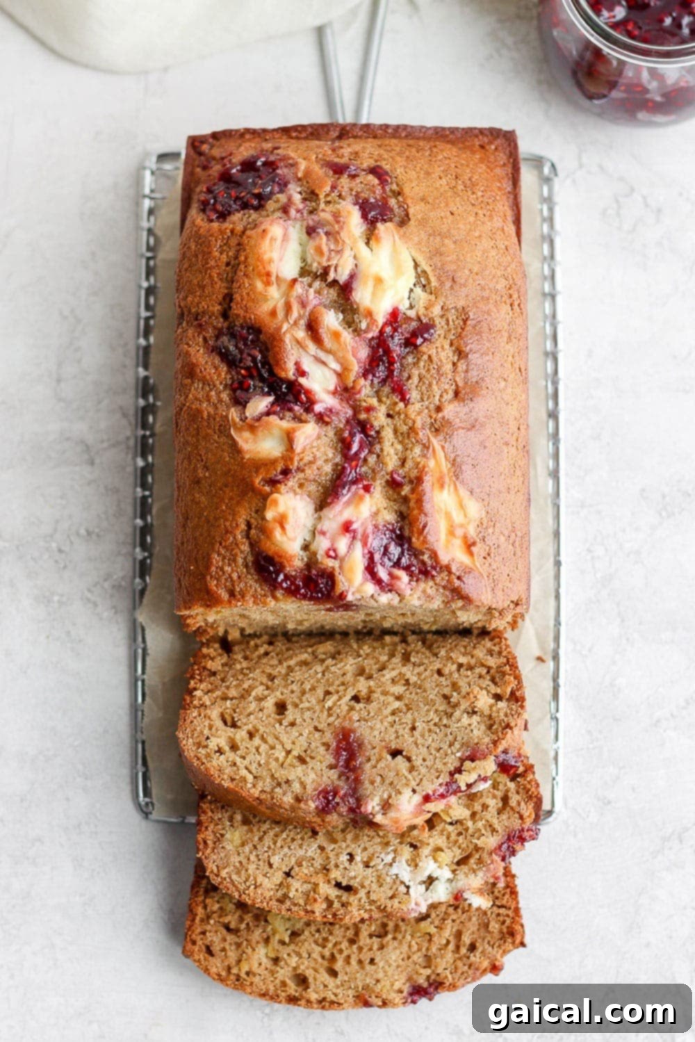 Sliced lemon bread revealing a beautiful raspberry cream cheese swirl