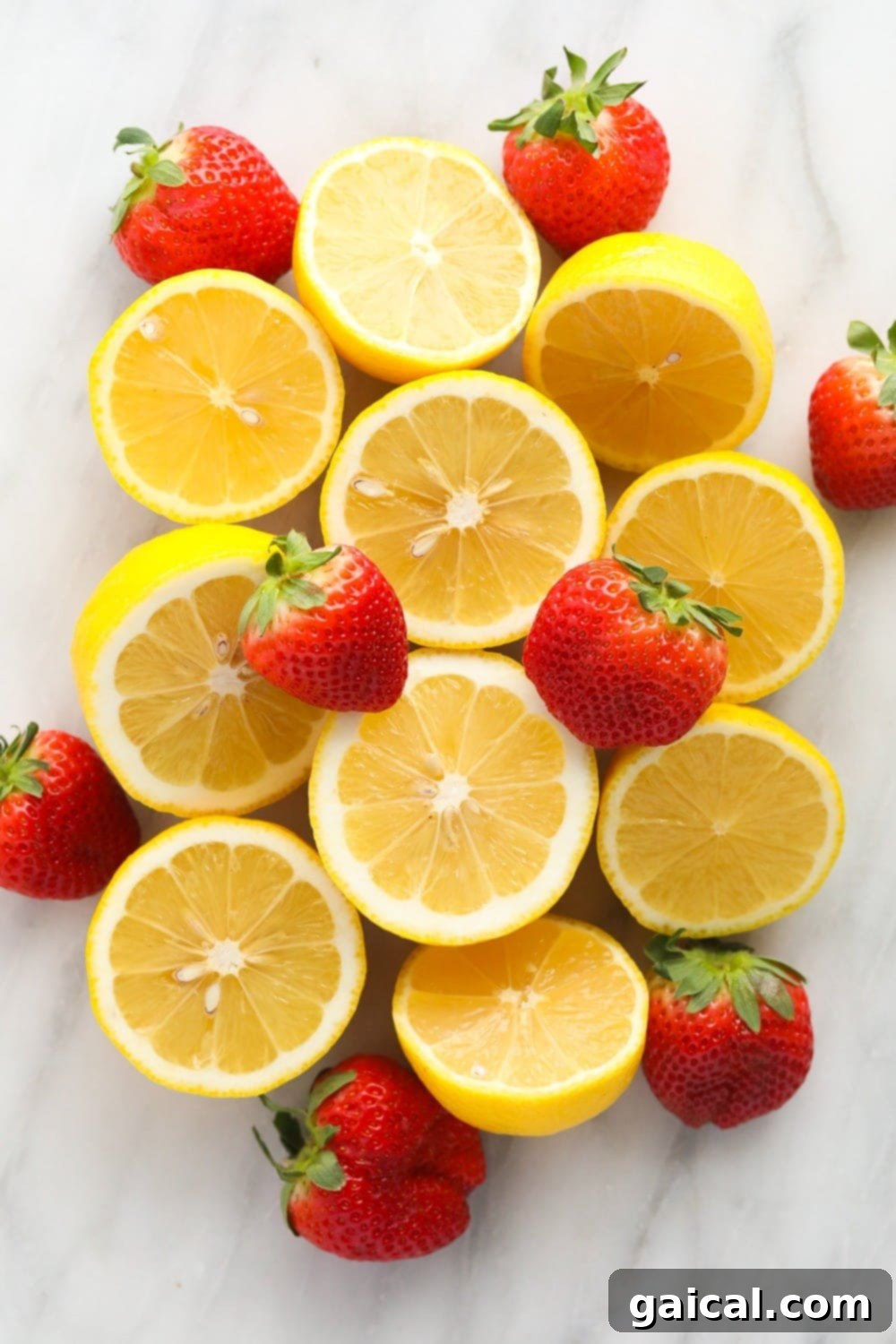 This Strawberry Vodka Lemonade is made with fresh strawberry puree, fresh squeezed lemons and a honey simple syrup, plus vodka, of course! Get ready for your new favorite homemade cocktail. A selection of fresh lemons and ripe strawberries, meticulously arranged and ready to be transformed into a delicious strawberry vodka lemonade.